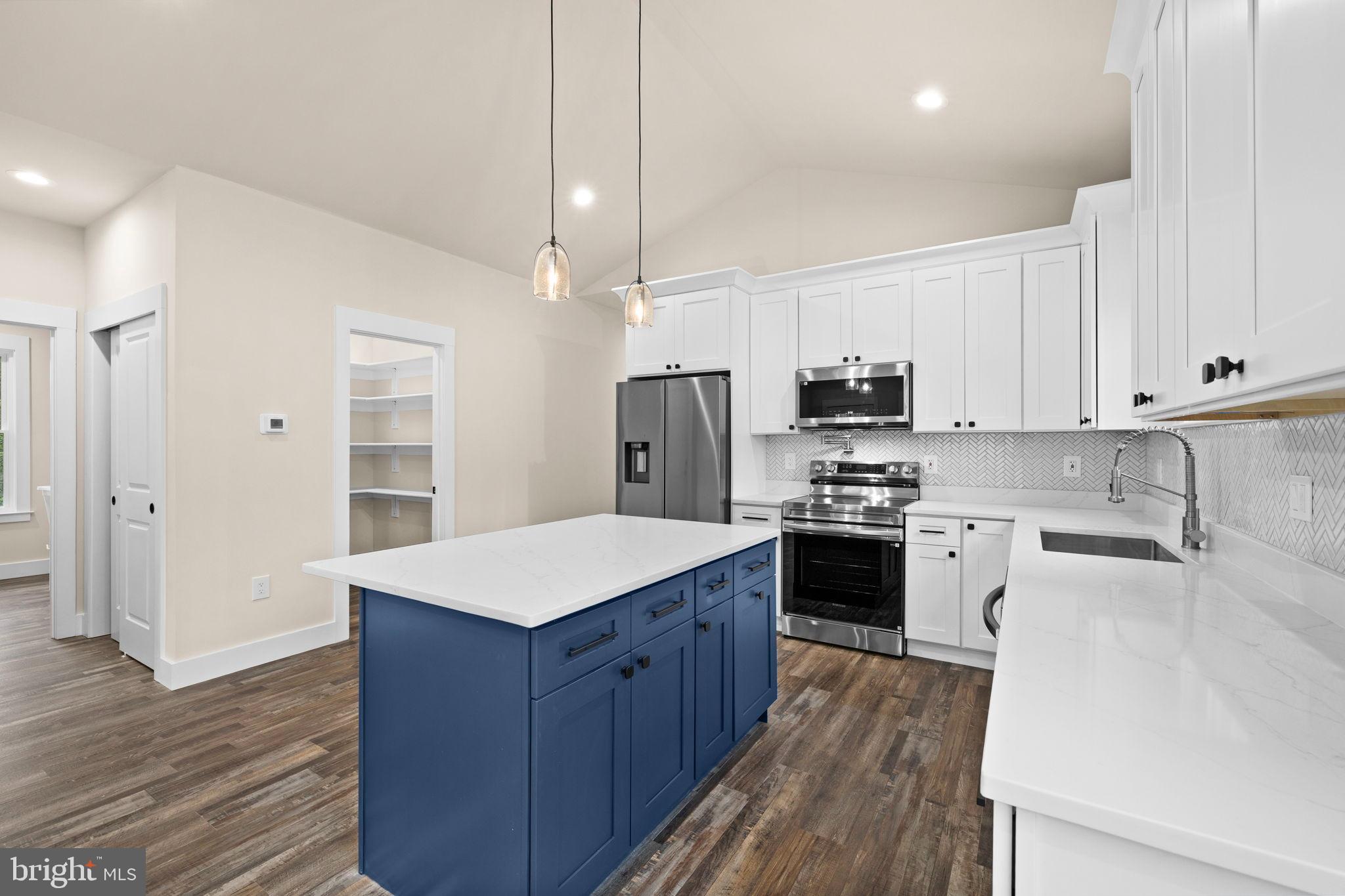312 9th Street Colonial Beach, VA 22443 - Photo 60 of 62 Modern kitchen with stylish blue island.