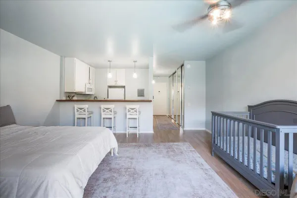 a spacious bedroom with a bed and a cabinets
