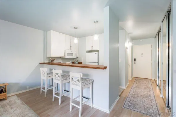 a view of kitchen with granite countertop cabinets table and chairs