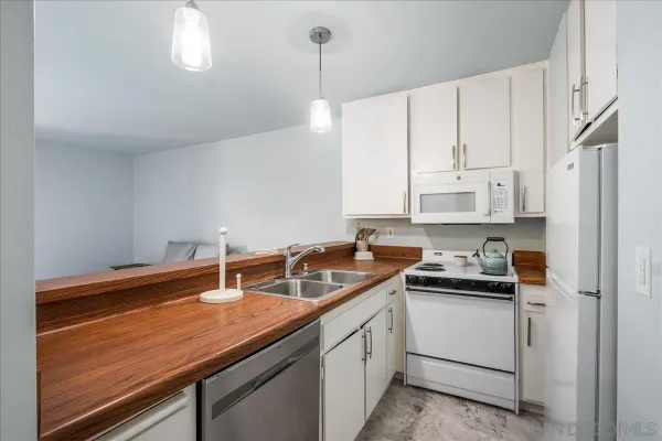 a kitchen with stainless steel appliances white cabinets and a sink