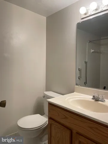 a bathroom with a sink a toilet and mirror