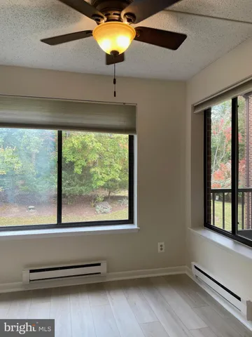 a view of room with window and ceiling fan