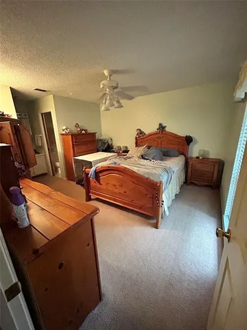 a spacious bedroom with two beds and a desk