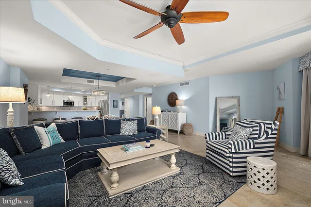 a kitchen with stainless steel appliances granite countertop a stove a refrigerator a sink dishwasher a dining table and chairs with wooden floor