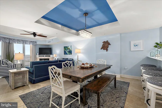 a kitchen with a dining table chairs refrigerator and microwave