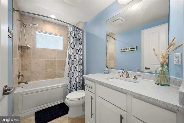 a dining room with furniture and floor to ceiling window