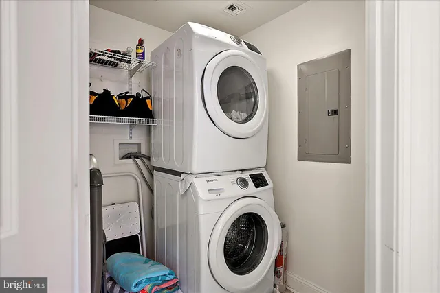 a view of a workspace with furniture and floor to ceiling window