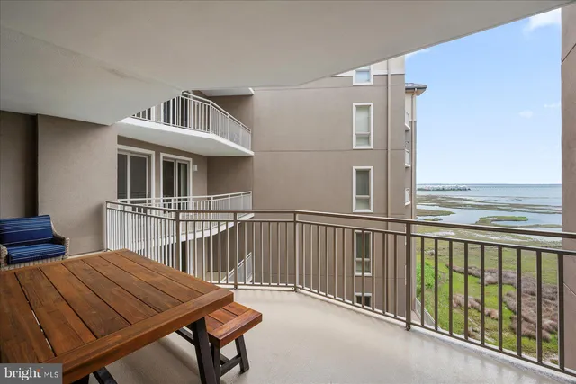 a view of a swimming pool with lawn chairs and a yard