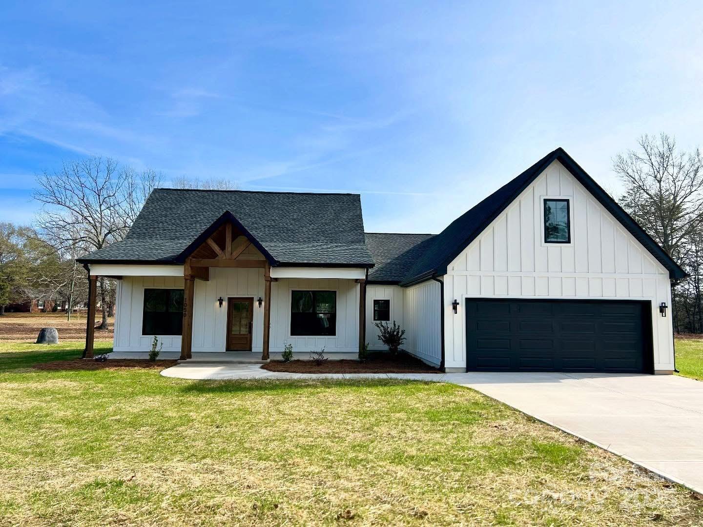 1050 Tom Joye Road Clover, SC 29710 - Photo 1 of 29 a front view of a house with a yard and garage