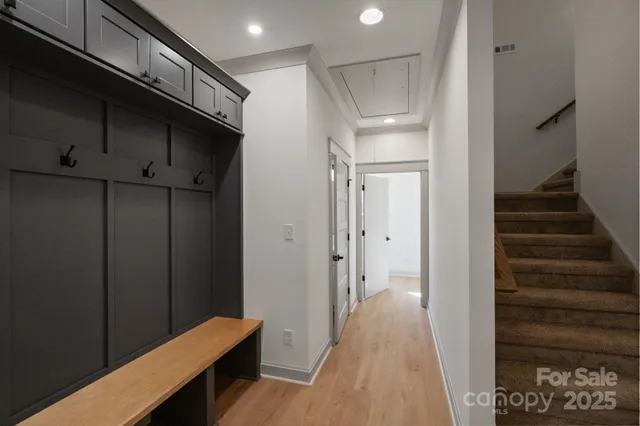 a view of a hallway with wooden floor and staircase