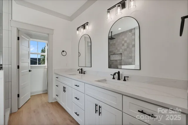 a bathroom with a double vanity sink mirror and
