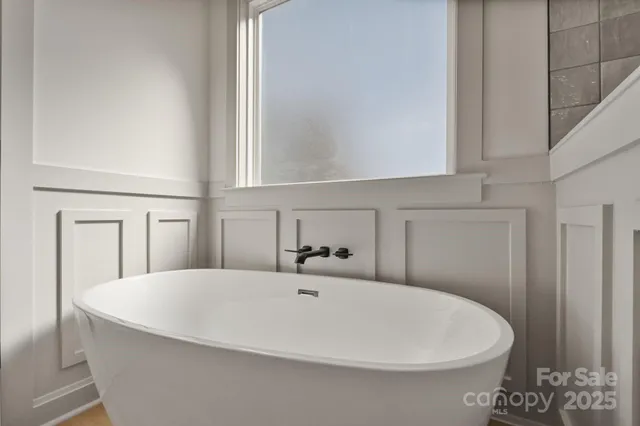 a white bath tub sitting in a bathroom