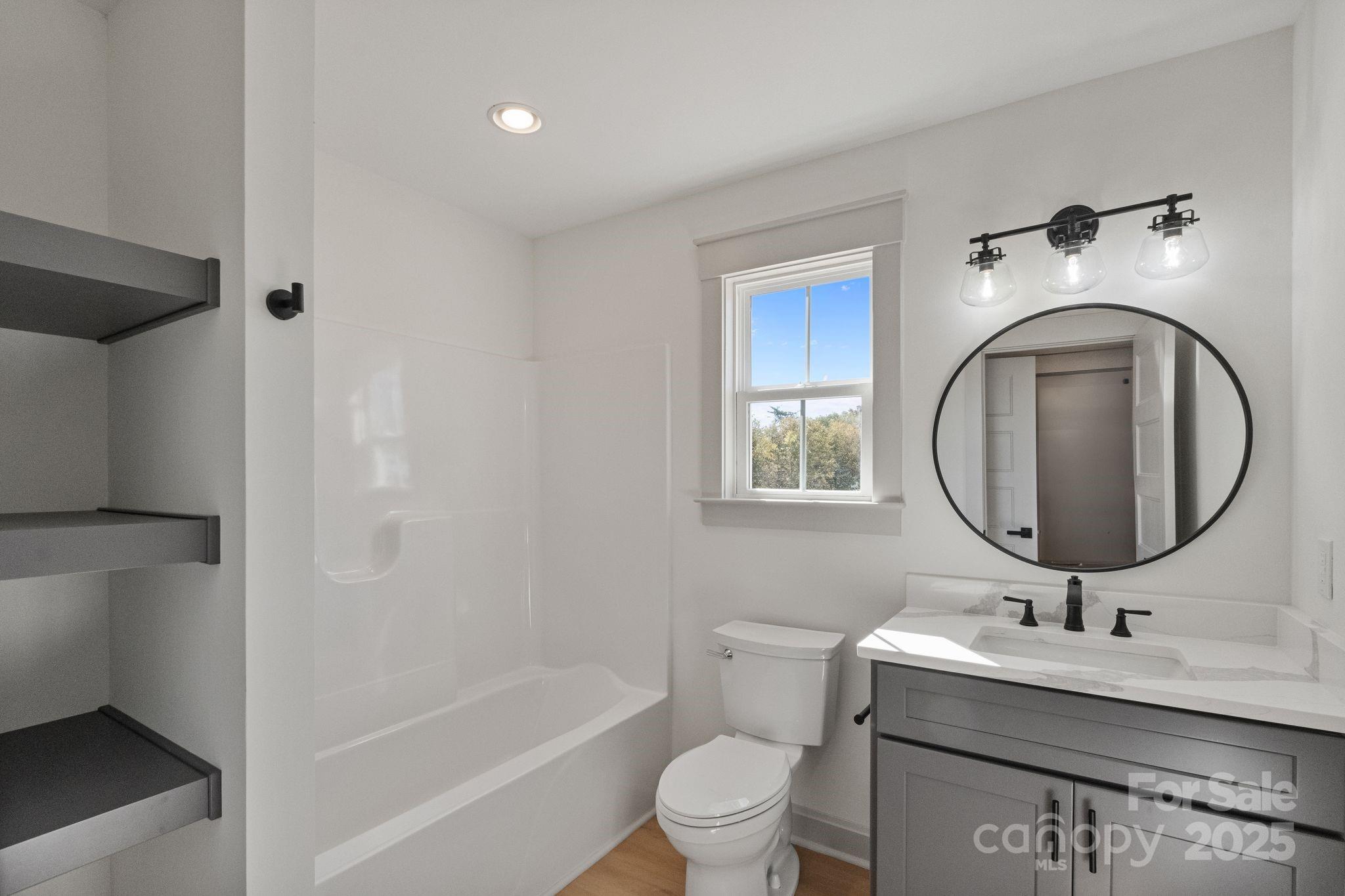 1050 Tom Joye Road Clover, SC 29710 - Photo 22 of 29 a bathroom with a toilet a sink and a mirror