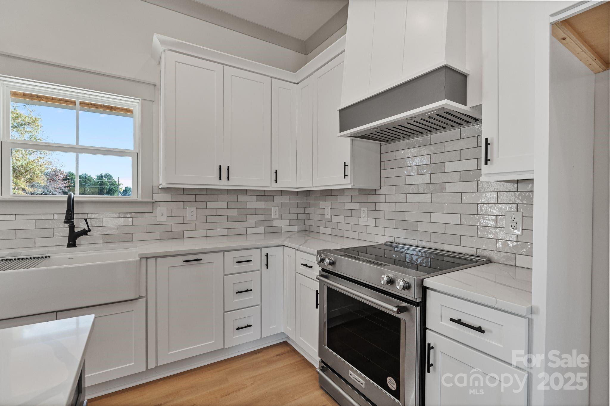 1050 Tom Joye Road Clover, SC 29710 - Photo 7 of 29 a kitchen with white cabinets appliances a sink and a window