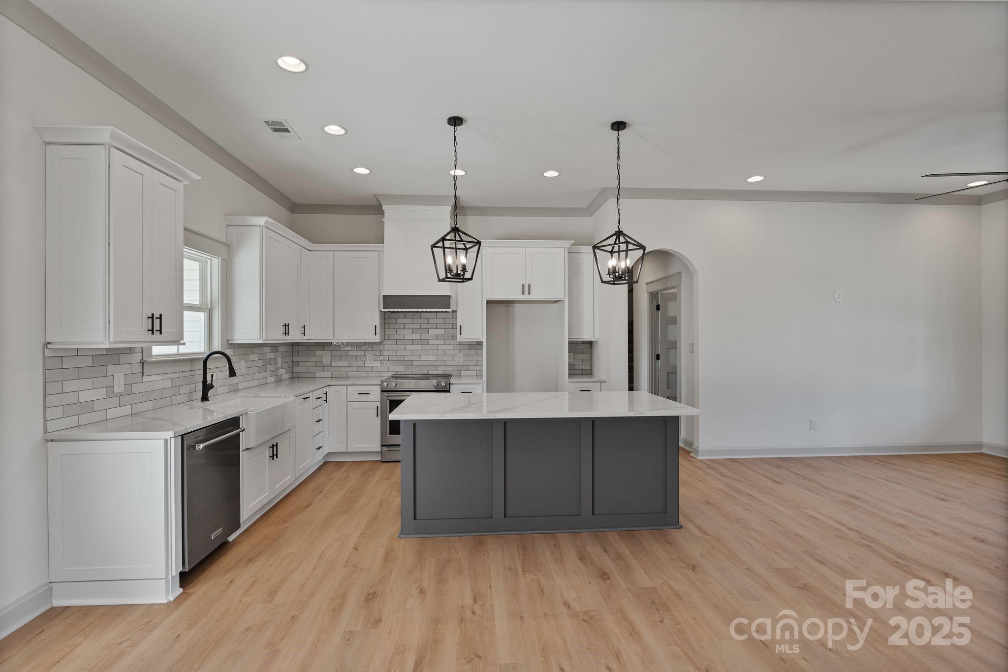 1050 Tom Joye Road Clover, SC 29710 - Photo 8 of 29 a large kitchen with granite countertop a sink a counter space appliances and cabinets