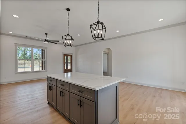 a view of a center island and wooden floor