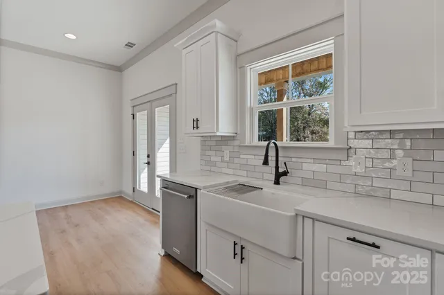 a kitchen with a sink and large window