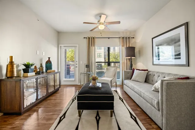 a living room with furniture and a chandelier