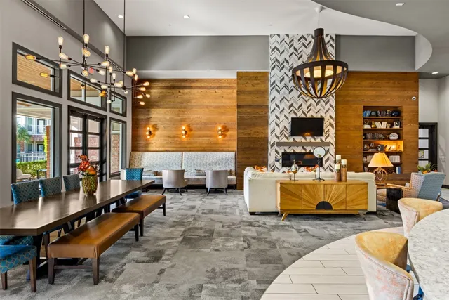 a living room with furniture kitchen view and a large window