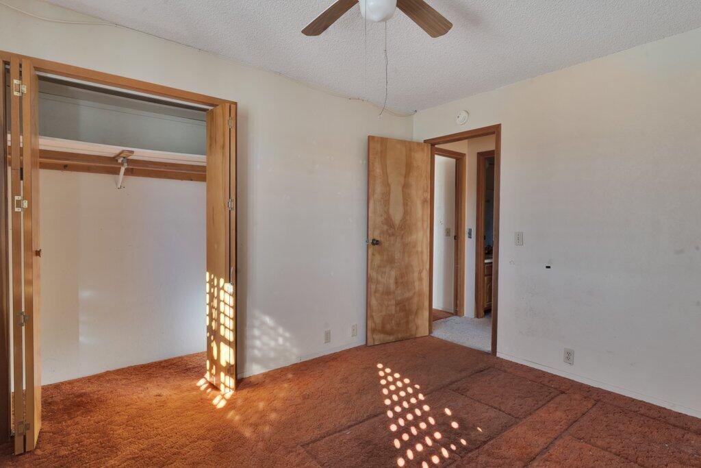 925 Inca Trail Yucca Valley, CA 92284 - Photo 13 of 31 an empty room with closet and a chandelier fan