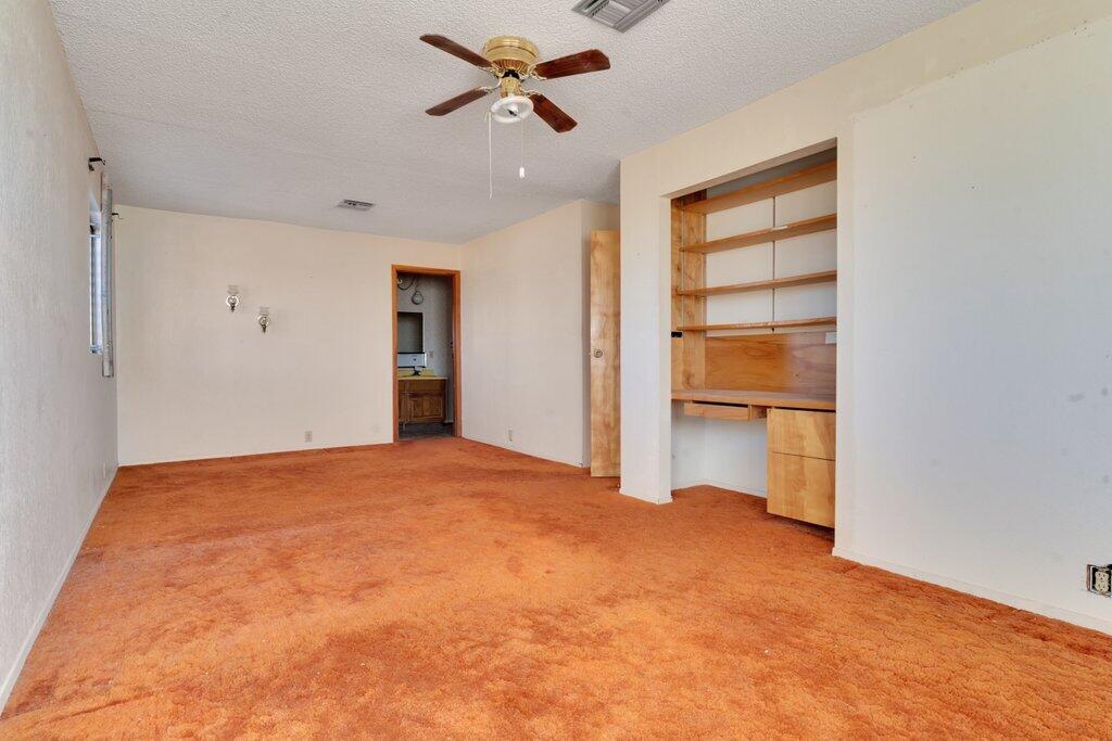 925 Inca Trail Yucca Valley, CA 92284 - Photo 14 of 31 a view of empty room with cabinet and ceiling fan