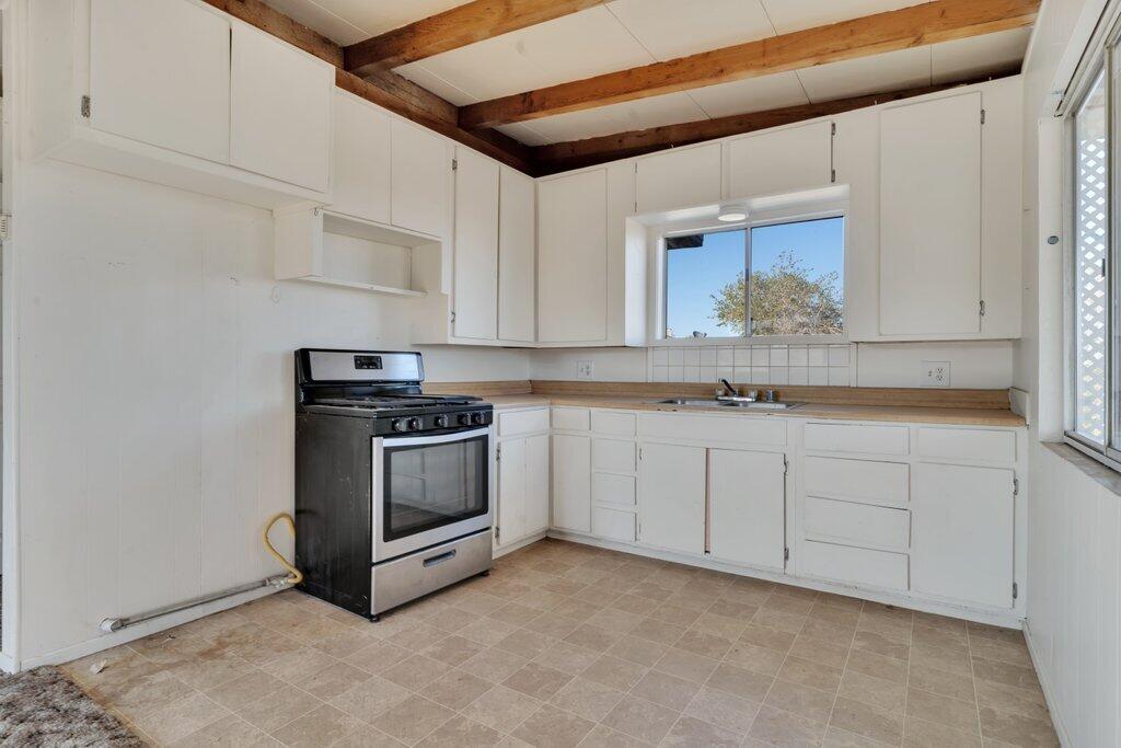 925 Inca Trail Yucca Valley, CA 92284 - Photo 21 of 31 a kitchen with granite countertop white cabinets and stainless steel appliances