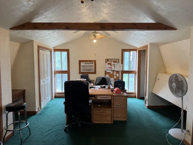a bedroom with furniture and a flat screen tv