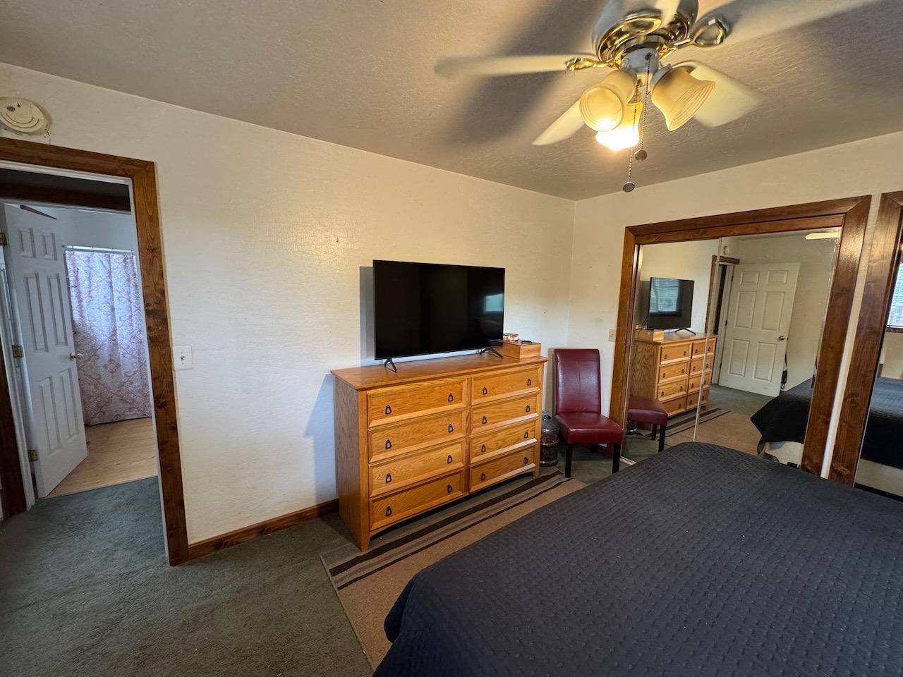 14950 Clinton Road Jackson, CA 95642 - Photo 14 of 50 a bedroom with furniture and a flat screen tv