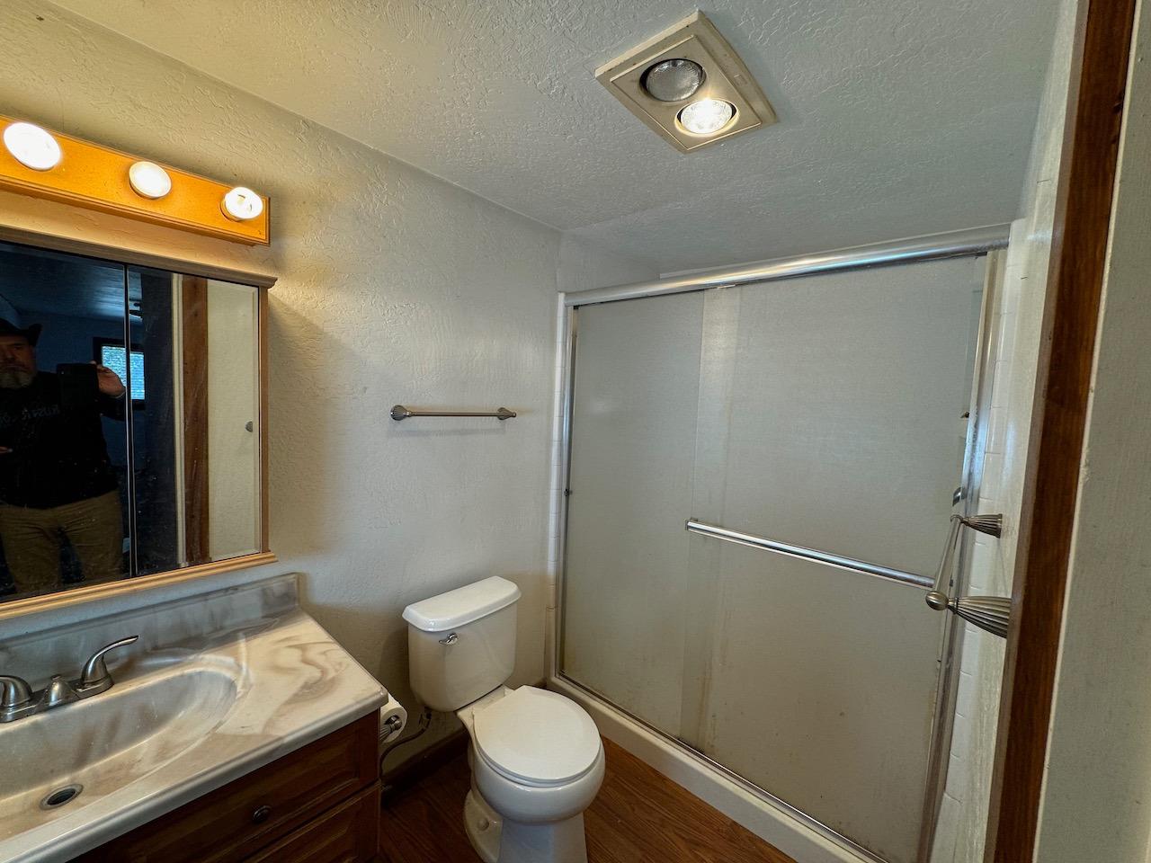 14950 Clinton Road Jackson, CA 95642 - Photo 37 of 50 a bathroom with a granite countertop sink toilet and shower