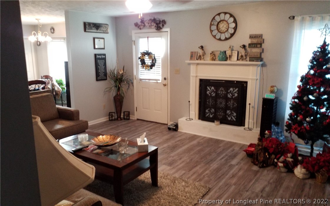 748 Rim Road Fayetteville, NC 28314 - Photo 6 of 18 a living room with furniture a window and a fireplace