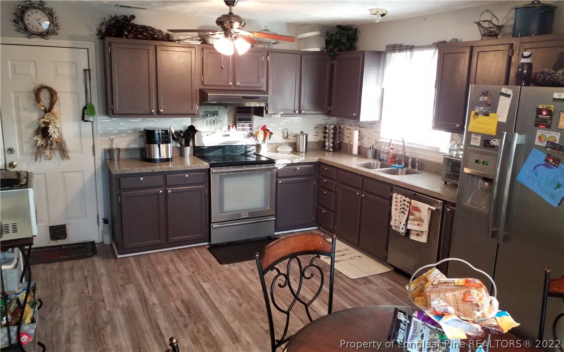 748 Rim Road Fayetteville, NC 28314 - Photo 8 of 18 a kitchen with granite countertop a sink appliances and cabinets