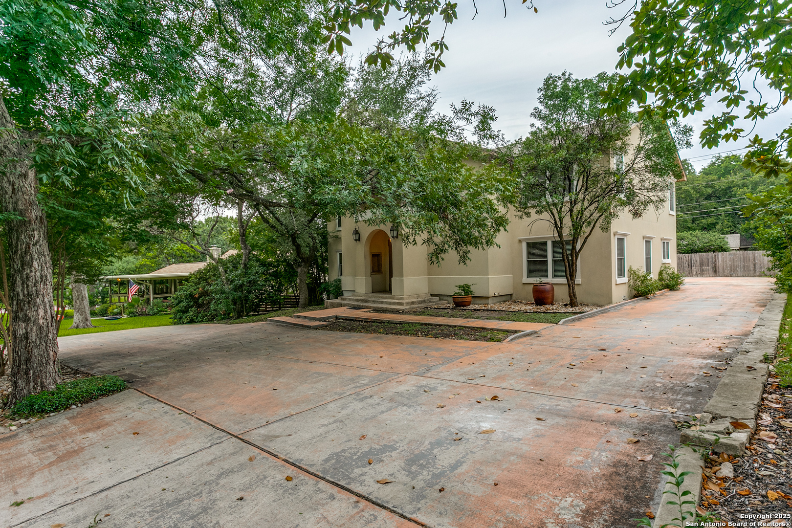 a view of a house with yard and sitting area