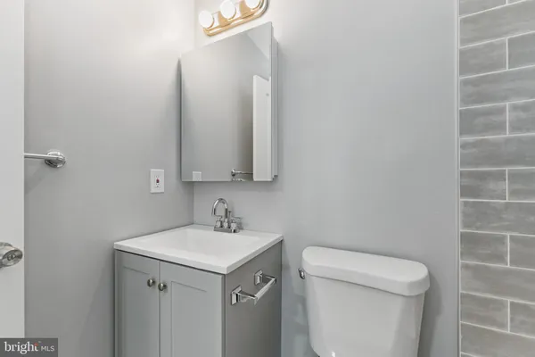 a view of bathroom with a toilet sink and mirror