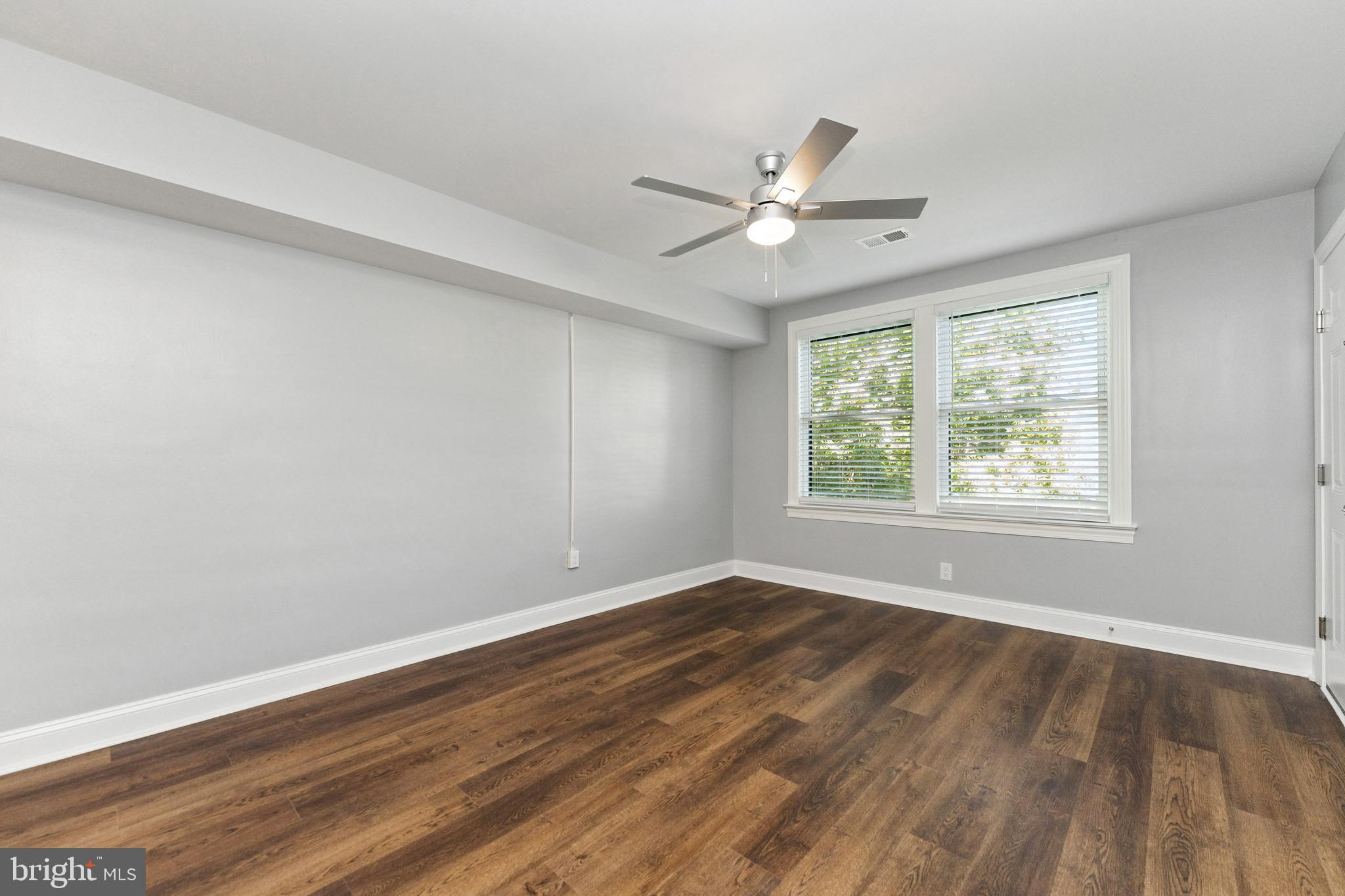 2021 E Street Northeast, Unit 2 Washington, DC 20002 - Photo 5 of 14 a view of an empty room with wooden floor and a window