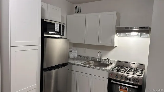 a kitchen with a refrigerator stove and microwave