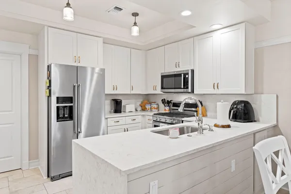 a kitchen with a sink stove and cabinets