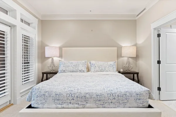 a bedroom with a large bed and a window