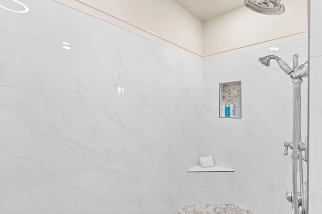 a bathroom with a double vanity sink mirror and shower