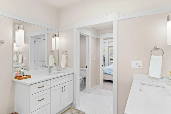 a bathroom with a double vanity sink mirror and shower