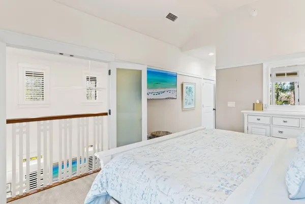 a bed room with a bed and a chair