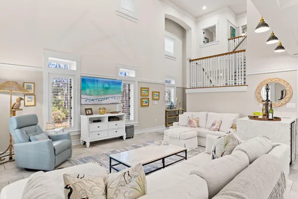 a kitchen with a sink a stove a refrigerator and white cabinets