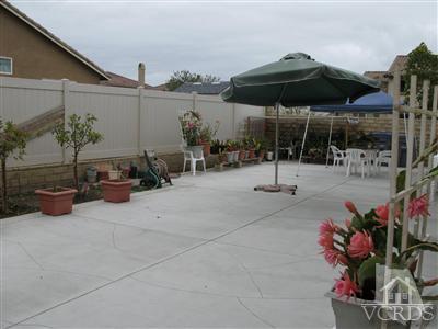640 Riviera Court Oxnard, CA 93035 - Photo 12 of 12 a view of a patio with a table and chairs under an umbrella