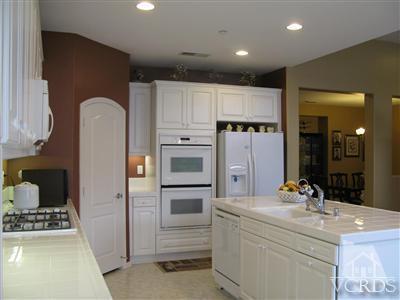 640 Riviera Court Oxnard, CA 93035 - Photo 4 of 12 a kitchen with kitchen island cabinets and refrigerator