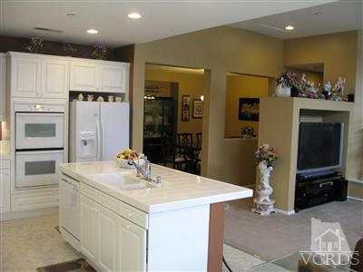 640 Riviera Court Oxnard, CA 93035 - Photo 6 of 12 a kitchen with stainless steel appliances kitchen island granite countertop a refrigerator and a stove top oven