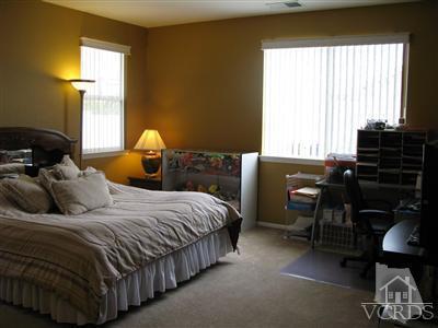640 Riviera Court Oxnard, CA 93035 - Photo 8 of 12 a bedroom with a bed and a window