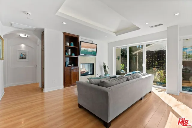 a living room with furniture and a floor to ceiling window