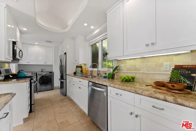 a kitchen with a sink stove and cabinets