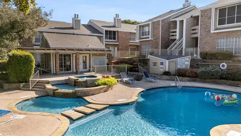 a front view of a house with swimming pool garden and patio