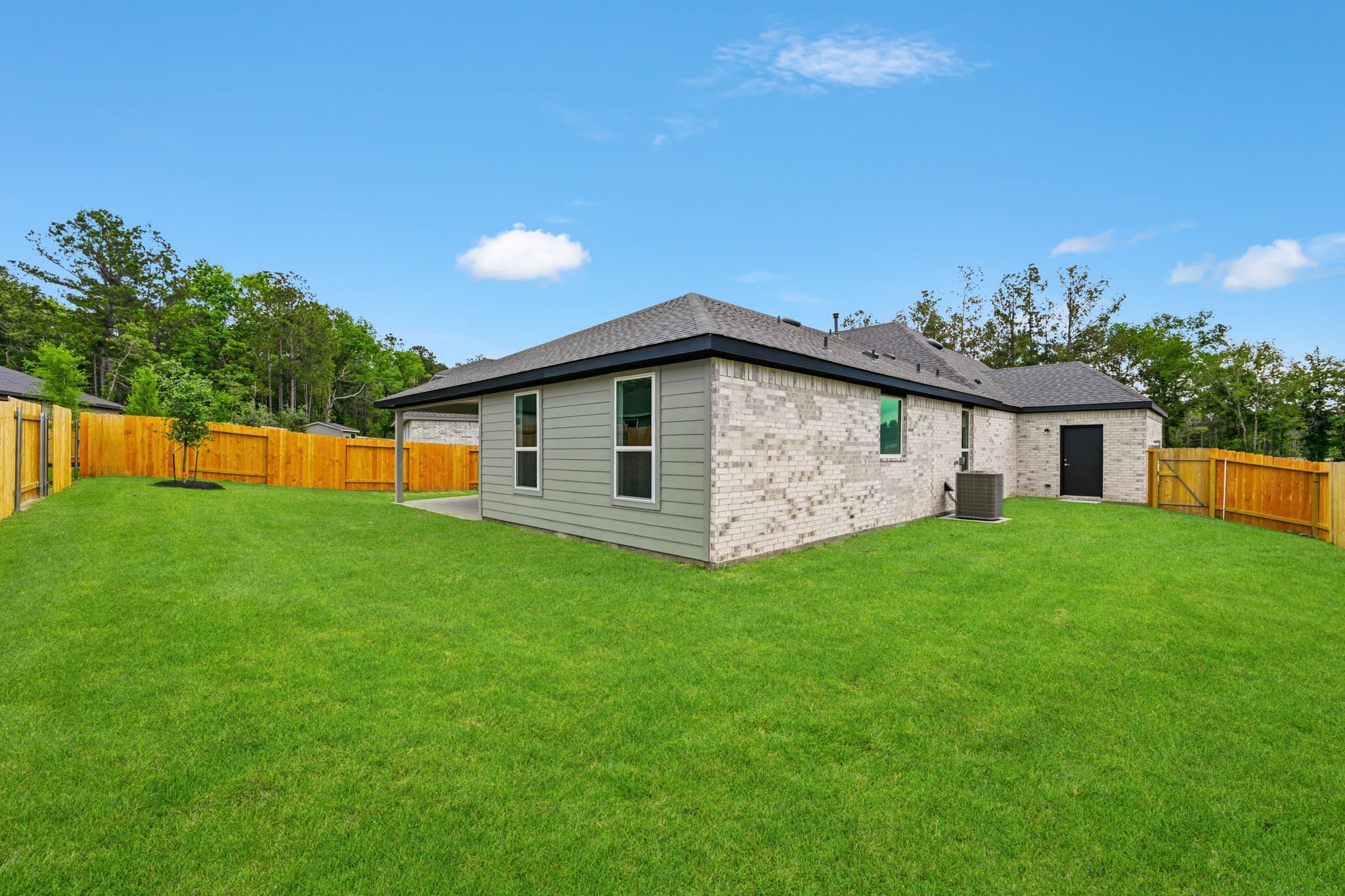 4613 Vernal Loop Conroe, TX 77303 - Photo 24 of 35 a front view of house with yard and trees in the background