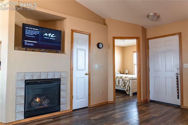 8298 Bohleen Road Peyton, CO 80831 - Photo 9 of 28 View of the Entry and living room with gas fireplace with new blower and 3rd bedroom in the background.